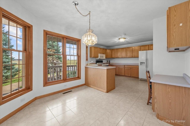 31-58 Wakonda Dr, Lake Carroll, IL 61046 - kitchen with white appliances, light countertops, a peninsula, and a chandelier