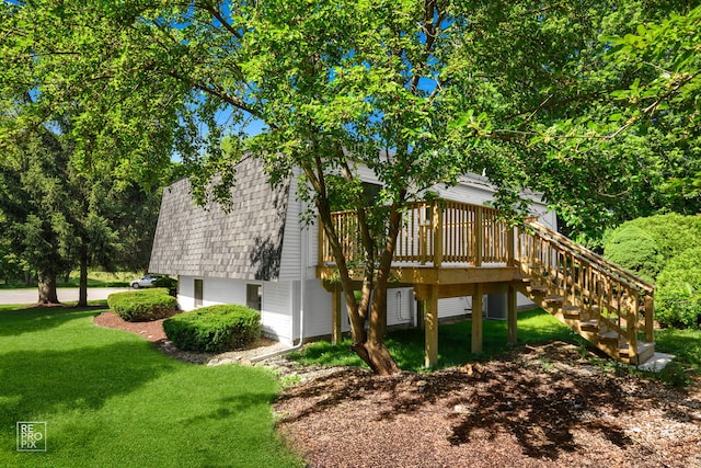 19228 W Quail Ct, Elwood, IL 60421 - view of property exterior featuring a lawn, a shingled roof, a deck, stairs, and a gambrel roof