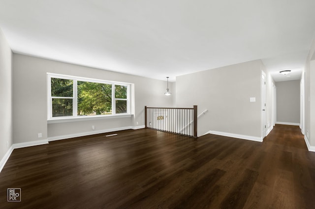 19228 W Quail Ct, Elwood, IL 60421 - empty room featuring dark wood-type flooring and baseboards