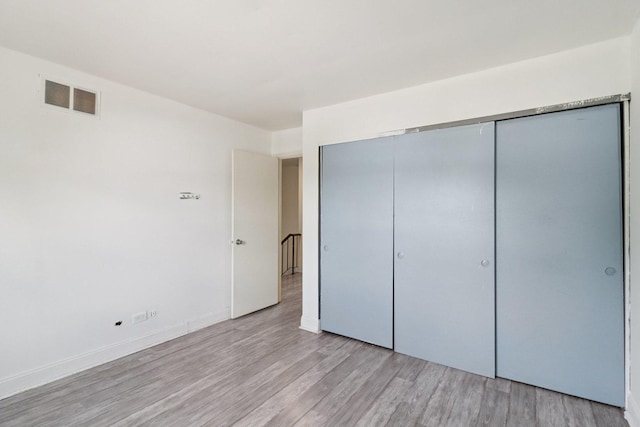 822 Texas Ct, Carol Stream, IL 60188 - unfurnished bedroom with light wood finished floors and a closet