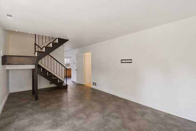 822 Texas Ct, Carol Stream, IL 60188 - unfurnished living room with stairway and finished concrete flooring