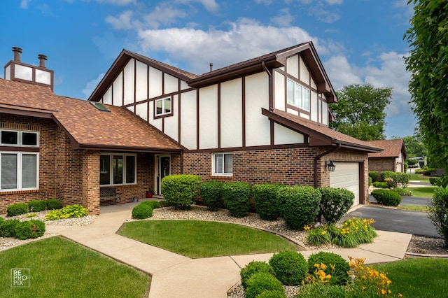 8909 Silverdale Dr Unit 5C, Orland Park, IL 60462 - view of front of property featuring brick siding, board and batten siding, a front yard, and driveway