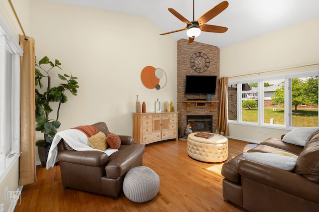 8909 Silverdale Dr Unit 5C, Orland Park, IL 60462 - living room with a stone fireplace, ceiling fan, wood finished floors, and high vaulted ceiling