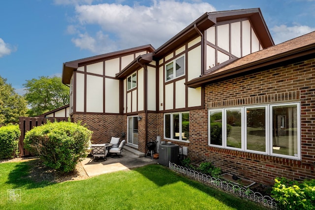 8909 Silverdale Dr Unit 5C, Orland Park, IL 60462 - rear view of house featuring brick siding, a patio area, a lawn, and stucco siding