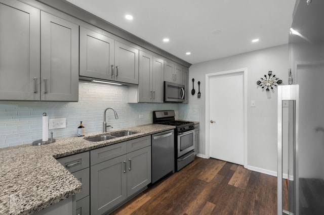 8909 Silverdale Dr Unit 5C, Orland Park, IL 60462 - kitchen with appliances with stainless steel finishes, gray cabinetry, dark wood-style floors, light stone counters, and backsplash