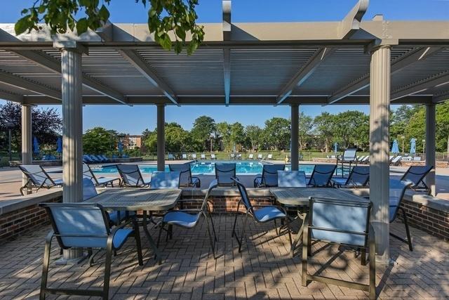 601 Lake Hinsdale Dr Unit 209, Willowbrook, IL 60527 - view of patio featuring a community pool, outdoor dining area, and a pergola