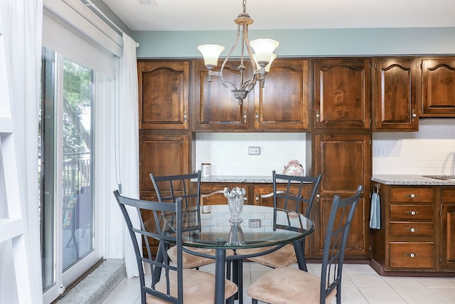 601 Lake Hinsdale Dr Unit 209, Willowbrook, IL 60527 - dining area with a chandelier and light tile patterned floors