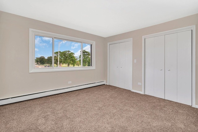 5724 111th St Unit 3A, Chicago Ridge, IL 60415 - unfurnished bedroom featuring multiple closets, baseboard heating, and carpet