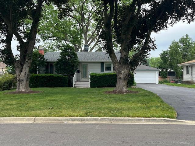 136 Ross Ave, Cary, IL 60013 - view of front of house with a front yard, a detached garage, and a chimney