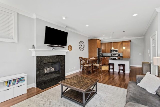 3938 N Southport Ave Unit G, Chicago, IL 60613 - living area with dark wood finished floors, a tile fireplace, recessed lighting, and crown molding