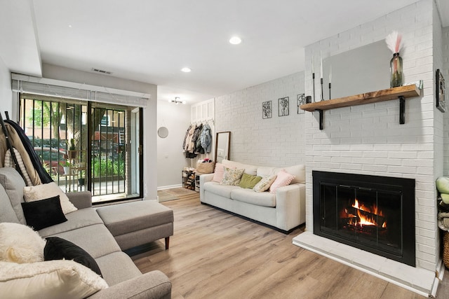 534 W Eugenie St, Chicago, IL 60614 - living room with a brick fireplace, light wood-type flooring, and recessed lighting