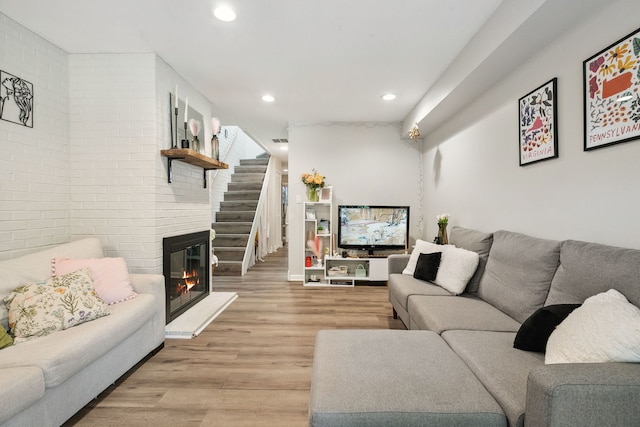 534 W Eugenie St, Chicago, IL 60614 - living area with brick wall, light wood-style flooring, recessed lighting, and a fireplace