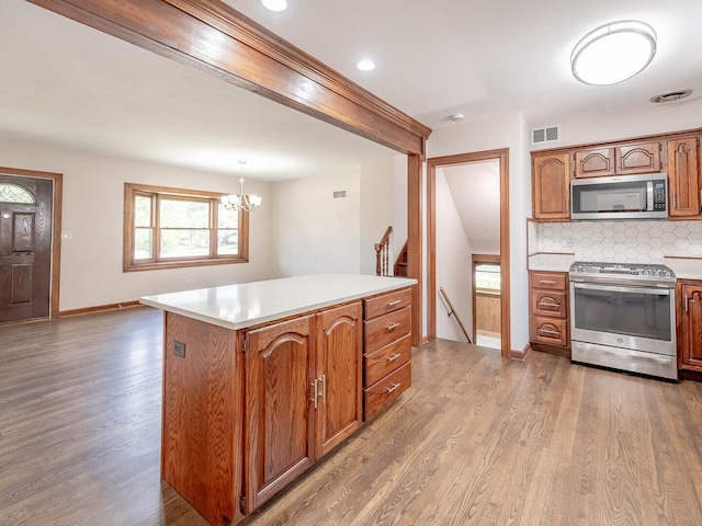 321 E Morningside Ave, Lombard, IL 60148 - kitchen featuring appliances with stainless steel finishes, light countertops, light wood-style floors, and tasteful backsplash