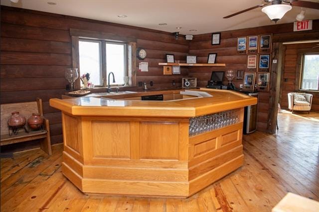 2003 W Hanover Rd, Hanover, IL 61041 - bar area with rustic walls, light wood-style flooring, ceiling fan, and black electric stovetop