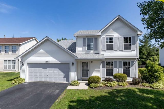 2054 Trafalger Ct, Romeoville, IL 60446 - traditional-style house featuring driveway, an attached garage, a front lawn, and a shingled roof