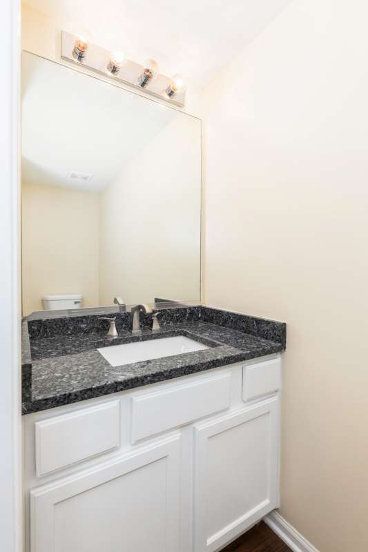 2054 Trafalger Ct, Romeoville, IL 60446 - half bathroom with vanity and wood finished floors