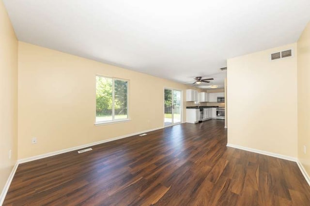 2054 Trafalger Ct, Romeoville, IL 60446 - unfurnished living room featuring dark wood-type flooring and a ceiling fan