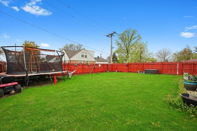 9631 Fullerton Ave, Franklin Park, IL 60131 - fenced backyard featuring a trampoline