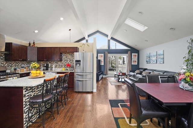 9631 Fullerton Ave, Franklin Park, IL 60131 - kitchen with stainless steel fridge, dark wood-style flooring, dark brown cabinets, a kitchen island, and a kitchen breakfast bar
