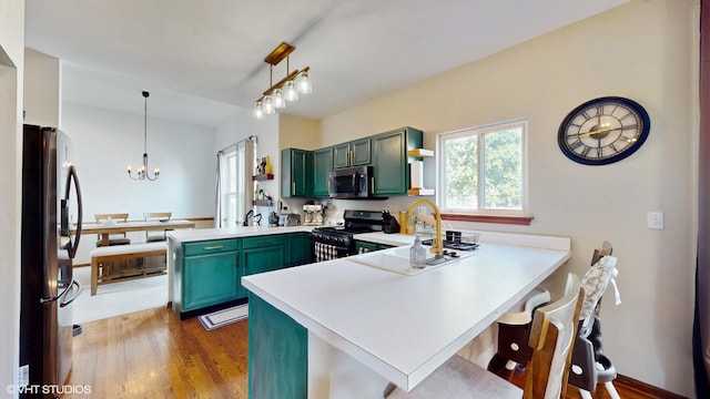 1389 Lily Cache Ln, Bolingbrook, IL 60490 - kitchen featuring green cabinetry, appliances with stainless steel finishes, a peninsula, open shelves, and light countertops