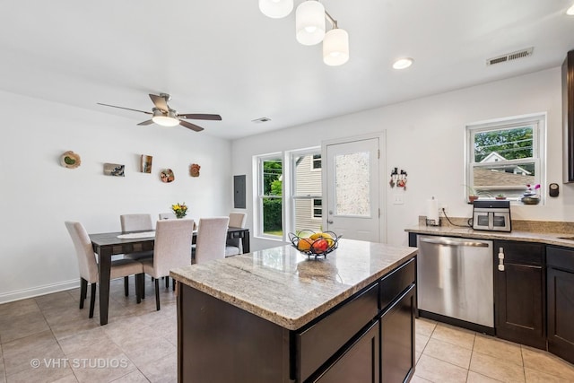 1828 Hovland Ct, Evanston, IL 60201 - kitchen featuring stainless steel dishwasher, a ceiling fan, light tile patterned flooring, a center island, and light stone counters