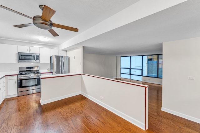 230 E Ontario St Unit 805, Chicago, IL 60611 - kitchen with stainless steel appliances, white cabinetry, wood finished floors, ceiling fan, and light countertops