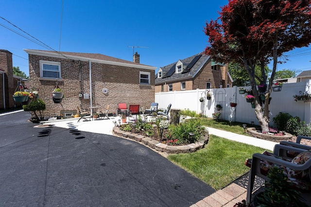 8805 S California Ave, Evergreen Park, IL 60805 - view of side of property featuring a fenced backyard, a patio area, brick siding, and a chimney