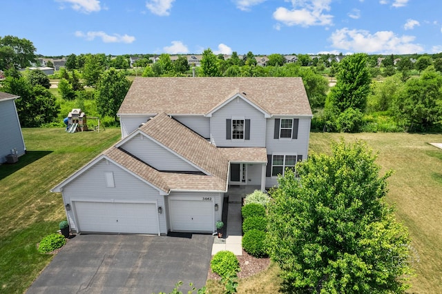 3462 Ayres Dr, Aurora, IL 60506 - traditional-style house with driveway, a garage, roof with shingles, a front yard, and a playground
