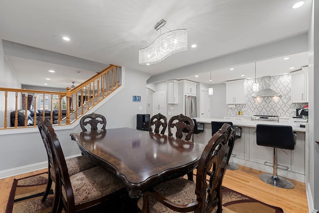 8313 W Ballard Rd, Niles, IL 60714 - dining area with light wood-style flooring, recessed lighting, stairs, and a chandelier