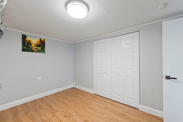 8313 W Ballard Rd, Niles, IL 60714 - unfurnished bedroom with light wood-type flooring, a closet, and ornamental molding
