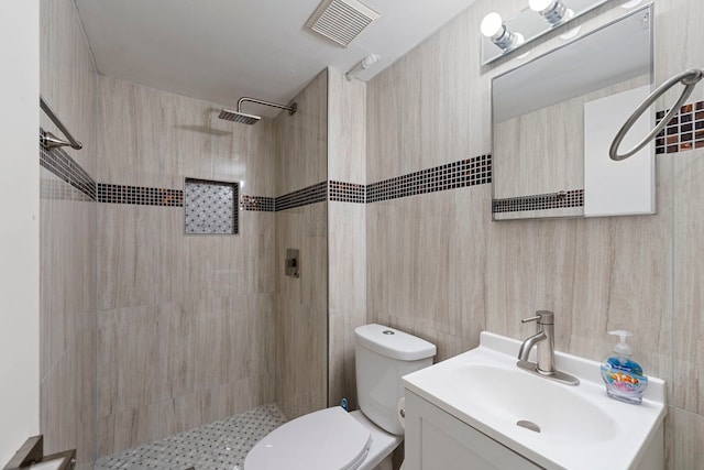 8313 W Ballard Rd, Niles, IL 60714 - bathroom featuring a tile shower, vanity, and tile walls