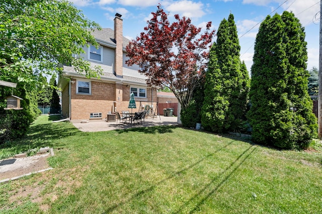 8313 W Ballard Rd, Niles, IL 60714 - back of property featuring a chimney, brick siding, and a patio area