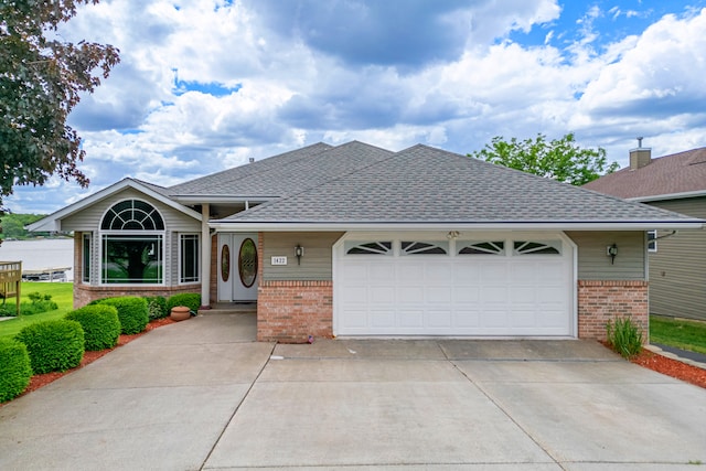 1422 Pier Dr, Lake Summerset, IL 61019 - view of front of home featuring brick siding, roof with shingles, concrete driveway, and a garage