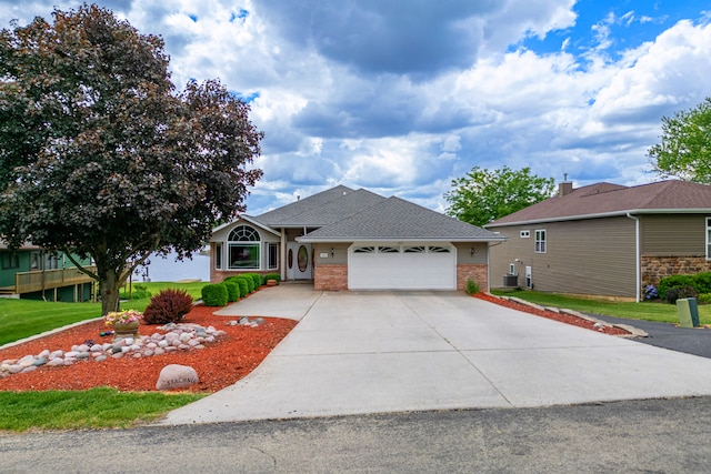 1422 Pier Dr, Lake Summerset, IL 61019 - ranch-style home with an attached garage, brick siding, driveway, a front yard, and a shingled roof
