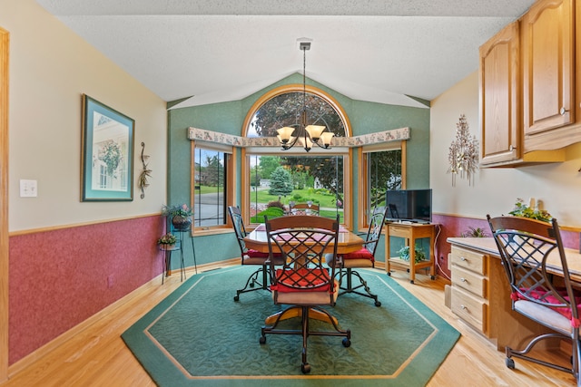 1422 Pier Dr, Lake Summerset, IL 61019 - dining area with a chandelier, light wood finished floors, lofted ceiling, and a wainscoted wall