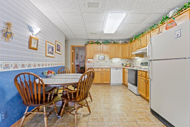 1422 Pier Dr, Lake Summerset, IL 61019 - kitchen with white appliances, under cabinet range hood, light countertops, a drop ceiling, and light brown cabinets