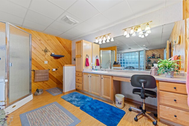 1422 Pier Dr, Lake Summerset, IL 61019 - full bath featuring a drop ceiling, wooden walls, a shower stall, vanity, and wood finished floors