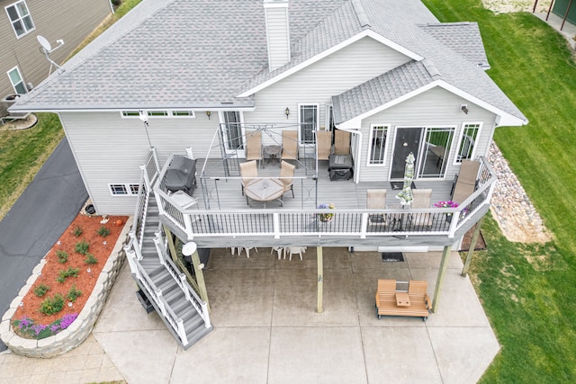 1422 Pier Dr, Lake Summerset, IL 61019 - rear view of house with outdoor dining space, a wooden deck, roof with shingles, and a yard