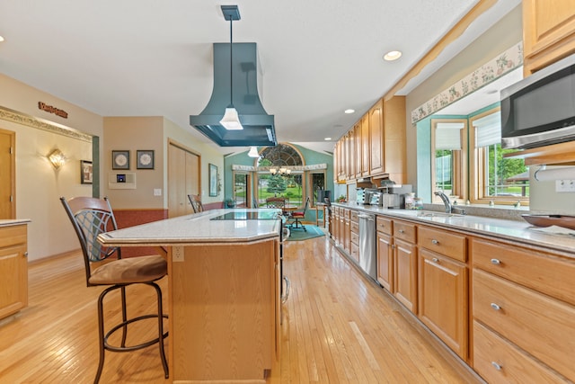 1422 Pier Dr, Lake Summerset, IL 61019 - kitchen with stainless steel appliances, light wood finished floors, range hood, a center island, and a kitchen breakfast bar