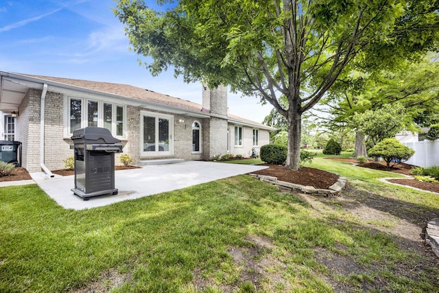 19635 Swanberg Ln, Mokena, IL 60448 - back of property with brick siding, a lawn, a chimney, and a patio area