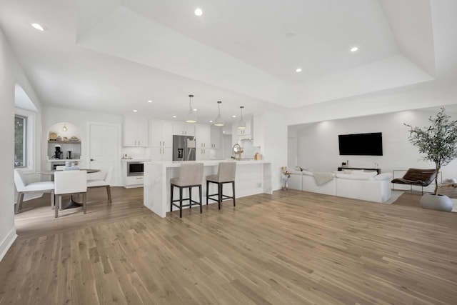 19635 Swanberg Ln, Mokena, IL 60448 - living area with a raised ceiling, light wood-style flooring, and recessed lighting