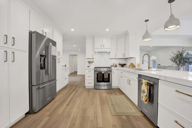 19635 Swanberg Ln, Mokena, IL 60448 - kitchen featuring stainless steel appliances, light countertops, light wood-style flooring, white cabinetry, and hanging light fixtures