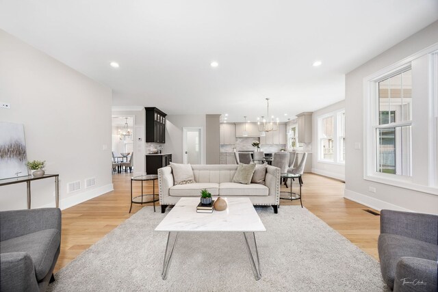 4508 Stonewall Ave, Downers Grove, IL 60515 - living room with a chandelier, light wood-style flooring, and recessed lighting