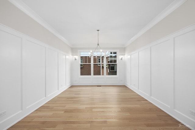 4508 Stonewall Ave, Downers Grove, IL 60515 - unfurnished dining area featuring a decorative wall, a chandelier, crown molding, and light wood finished floors