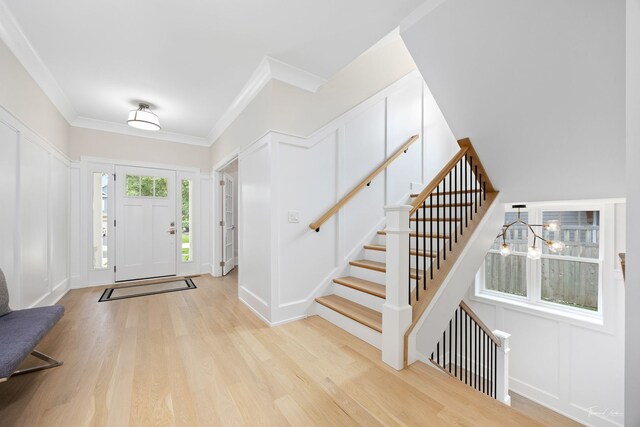 4508 Stonewall Ave, Downers Grove, IL 60515 - entrance foyer featuring a decorative wall, light wood-style floors, ornamental molding, a chandelier, and stairs