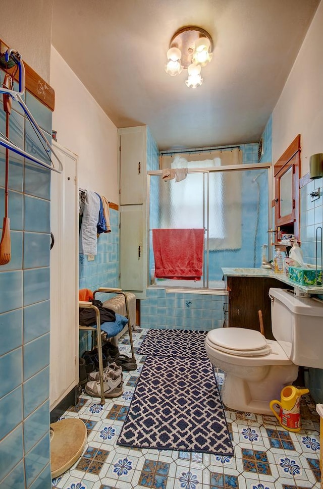 5145 S Troy St, Chicago, IL 60632 - bathroom with an enclosed shower, tile walls, tile patterned floors, and wainscoting