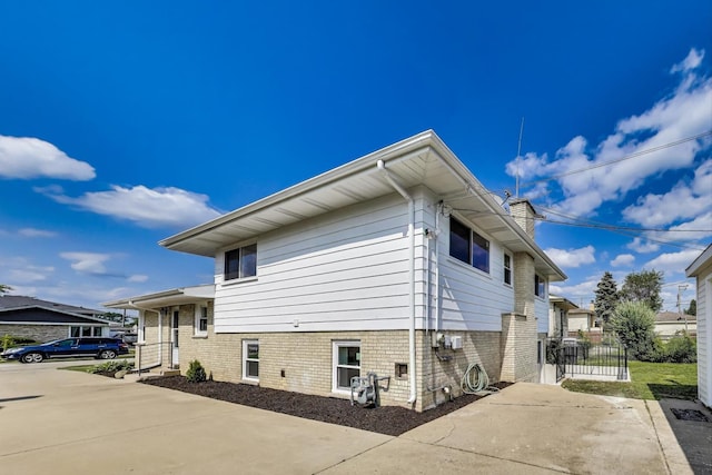 8433 W Betty Ter W, Niles, IL 60714 - view of side of home featuring a chimney and a gate
