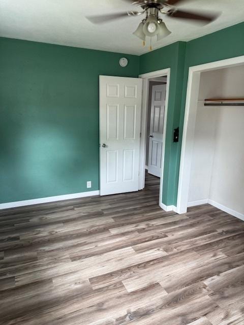 4714 Pine Al St, Machesney Park, IL 61115 - unfurnished bedroom featuring a closet, wood finished floors, and a ceiling fan