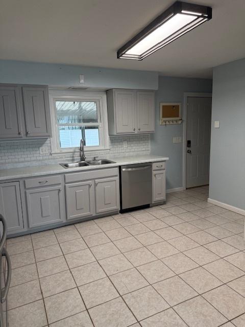 4714 Pine Al St, Machesney Park, IL 61115 - kitchen with stainless steel dishwasher, gray cabinetry, decorative backsplash, and light countertops
