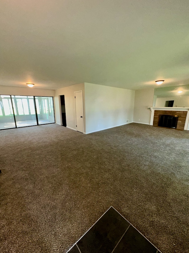 207 Dodge Ave, Danville, IL 61832 - unfurnished living room featuring carpet floors and a fireplace